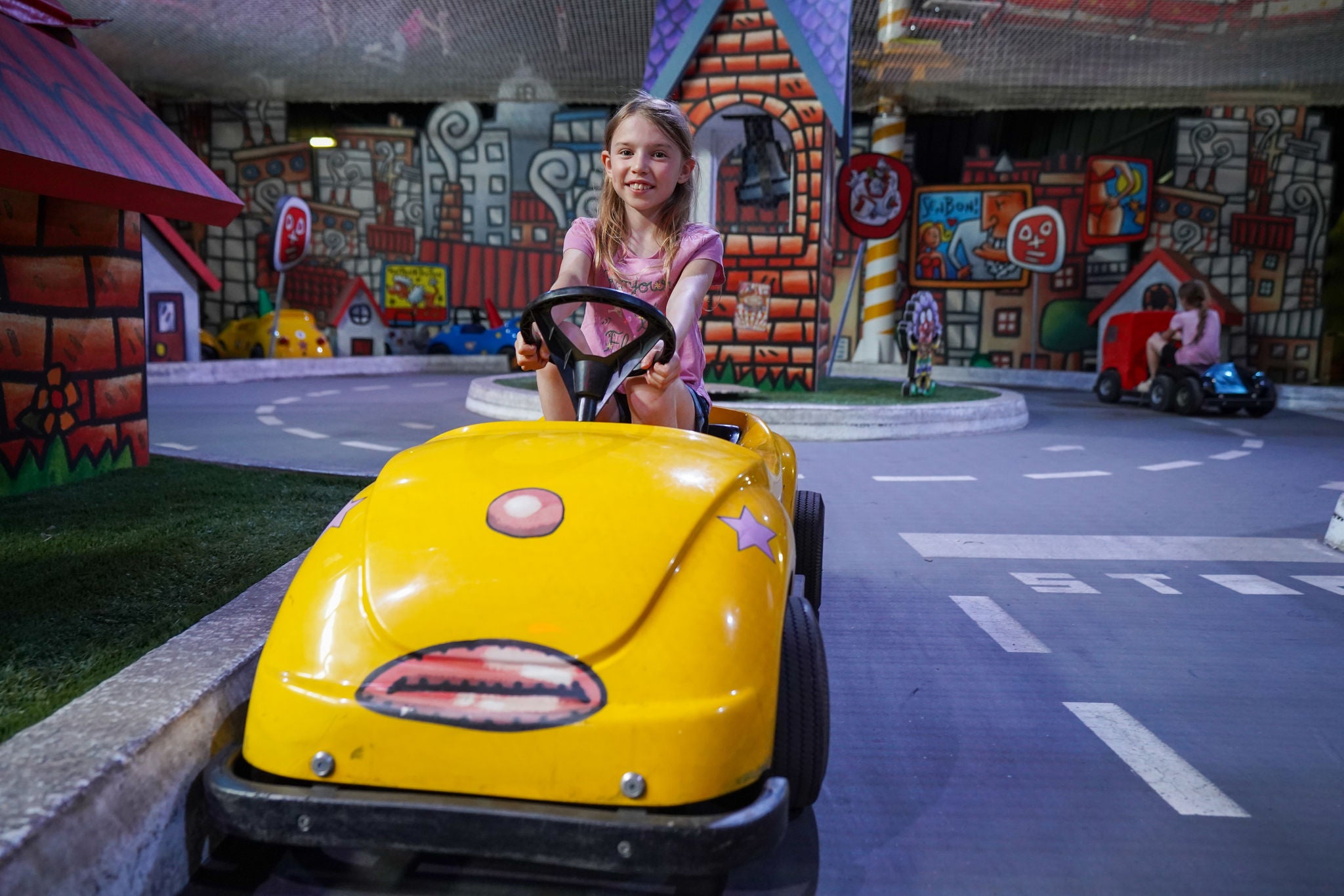 Little girl riding car at France Miniature