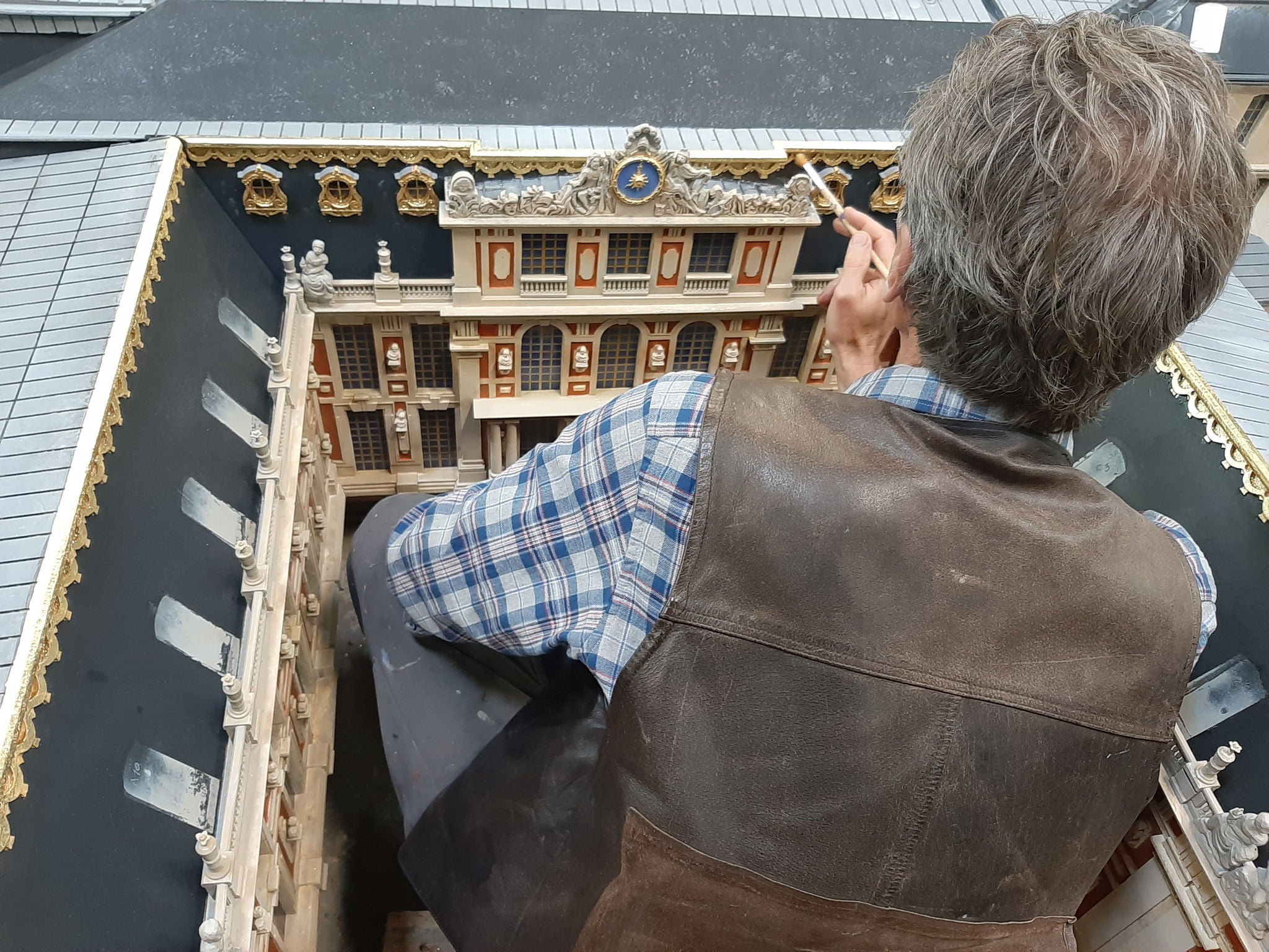 Model Maker working on the miniature version of Palace of Versailles at France Miniature