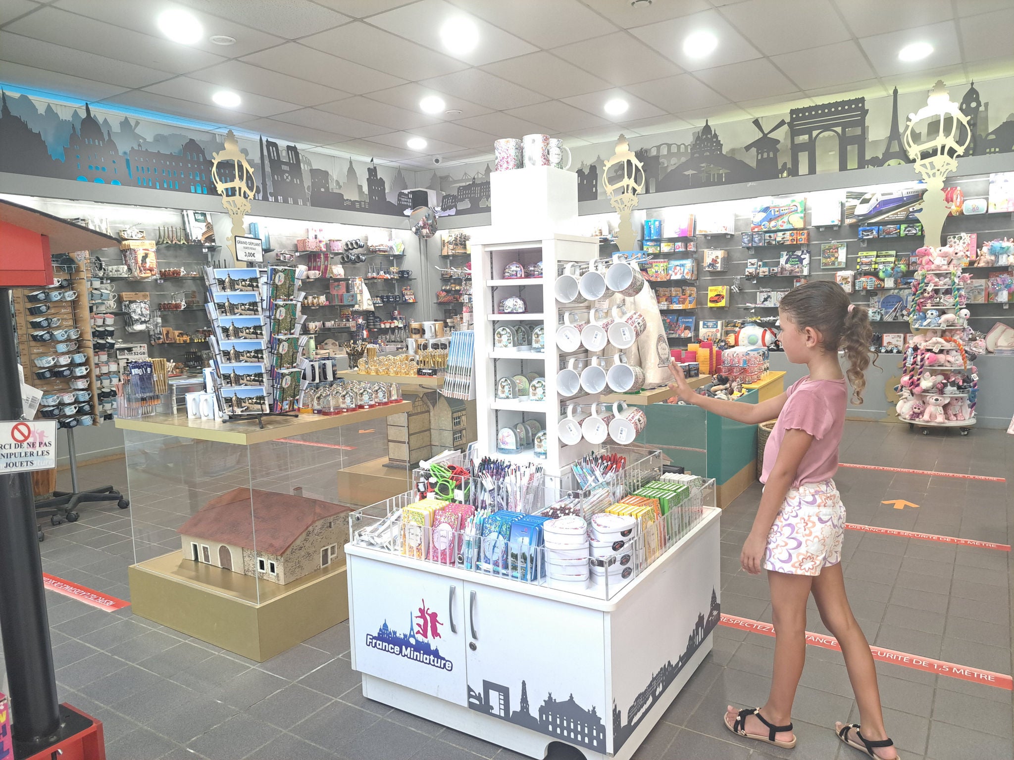 Girl browsing the souvenir ship at France Miniature